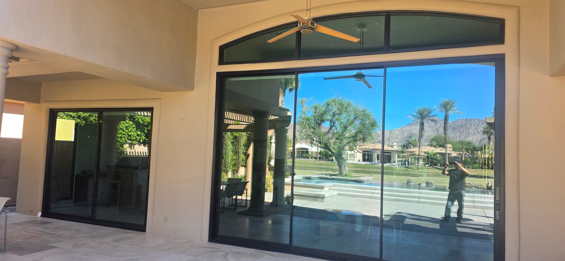 Large sliding glass door with arched transom